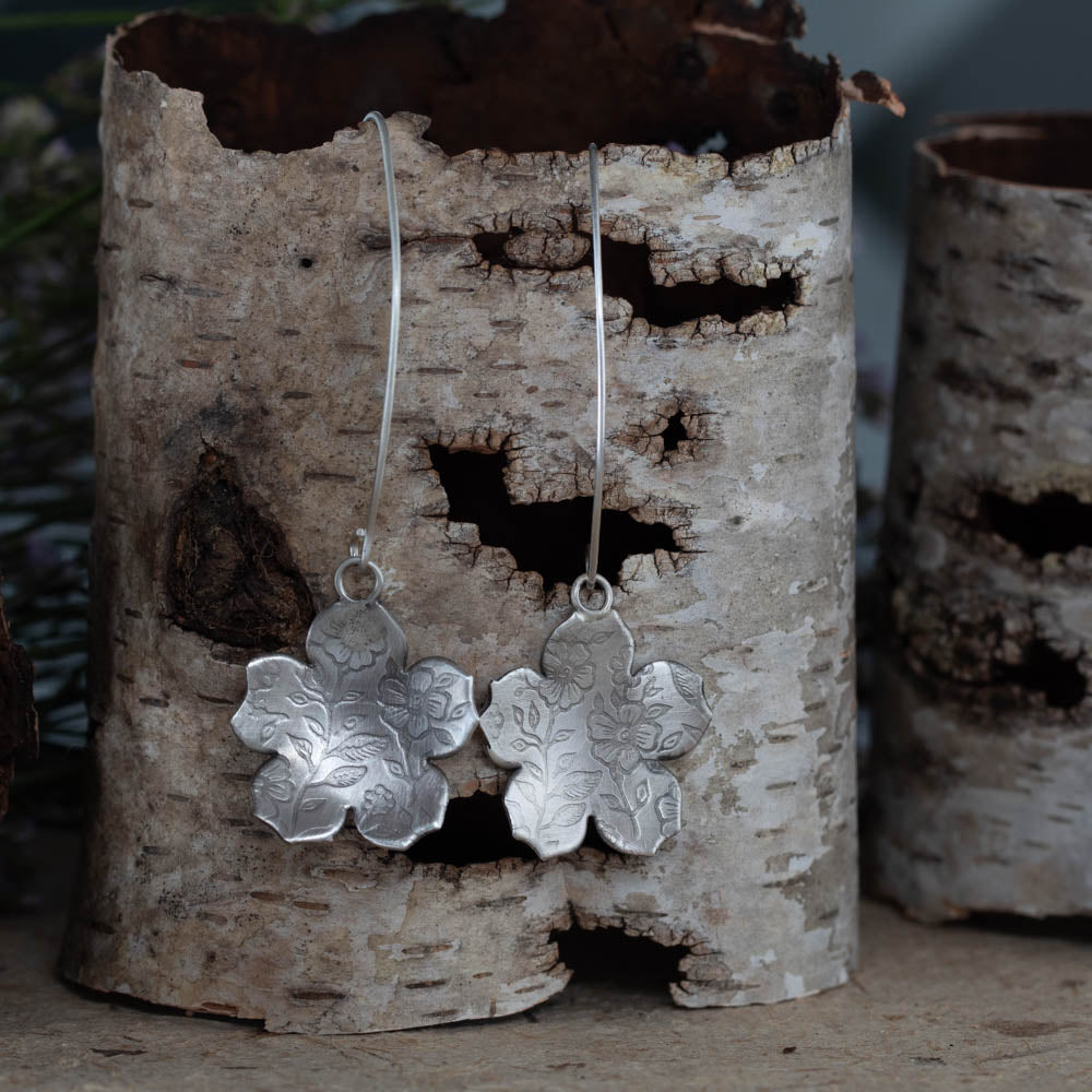 Sterling silver botanical impression earrings by Divella Designs, handmade in Vermont with floral textured pattern and satin finish, 2 1/2" drop on curved ear wires