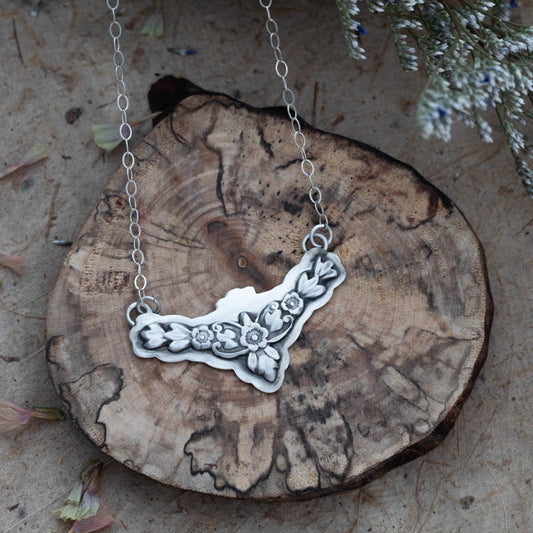 Sterling silver botanical garland necklace with floral and leaf details, formed and finished by hand.