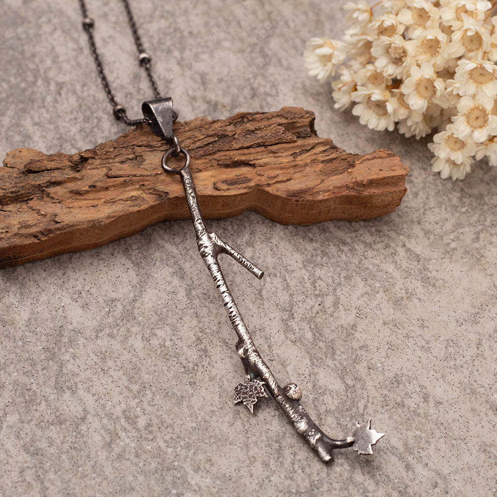 Handmade fused sterling silver necklace with detailed 3 1/4" branch pendant and tiny maple leaves on an 18-inch oxidized chain, woodland nature jewelry.