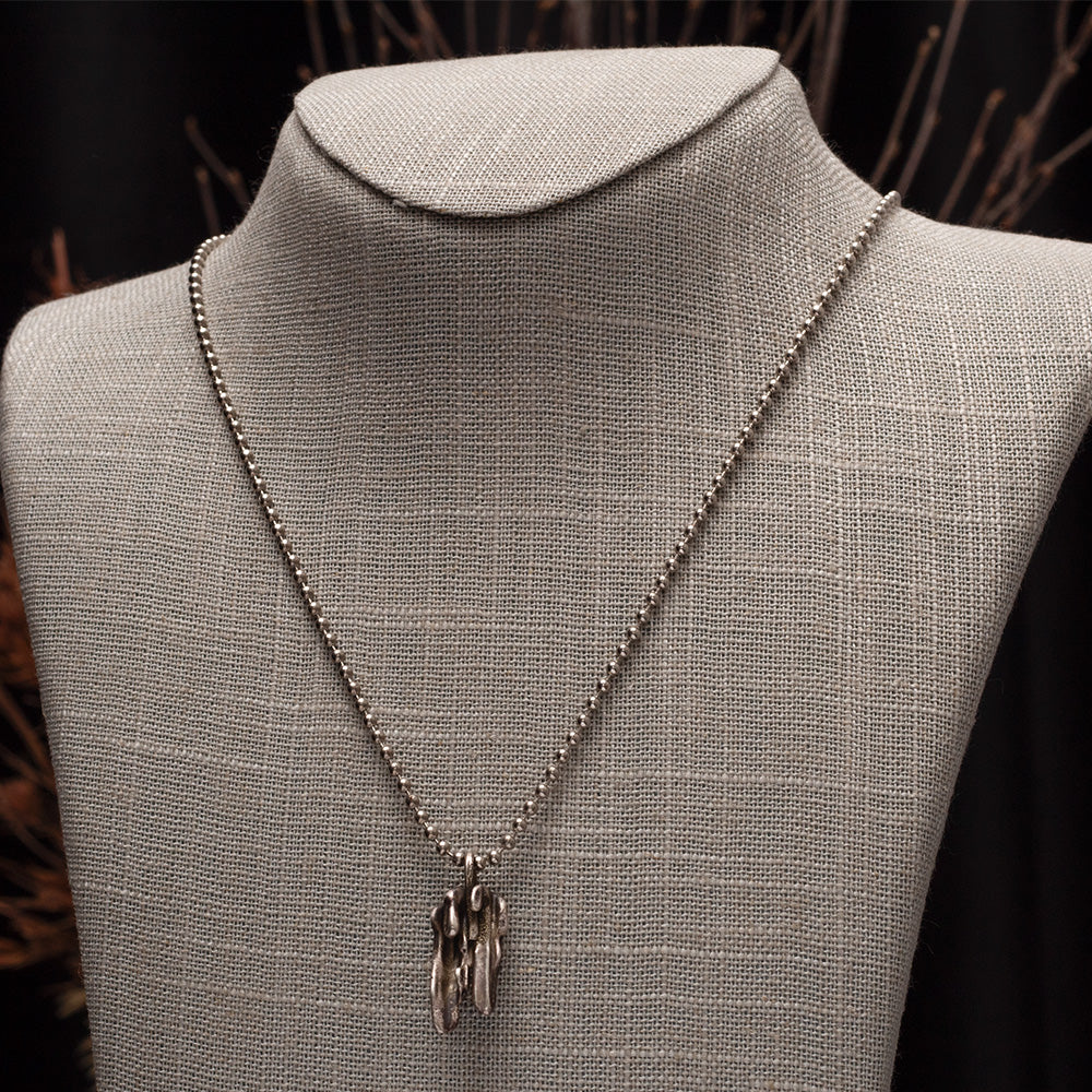 Handmade broom-cast sterling silver necklace created from recycled scrap silver, unique organic pendant on silver chain.