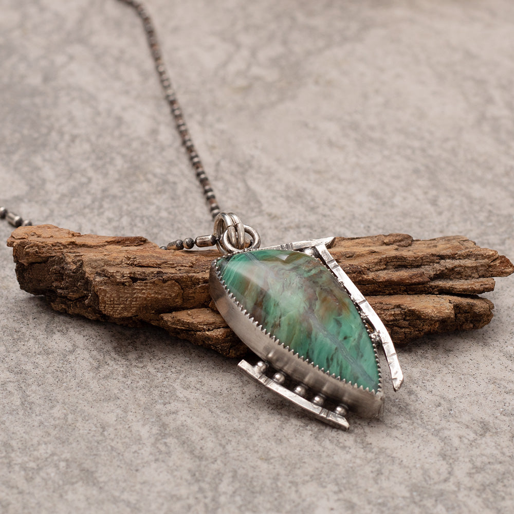 Handcrafted sterling silver pendant necklace featuring a green Kingman turquoise stone with modern geometric bezel setting on beaded chain.