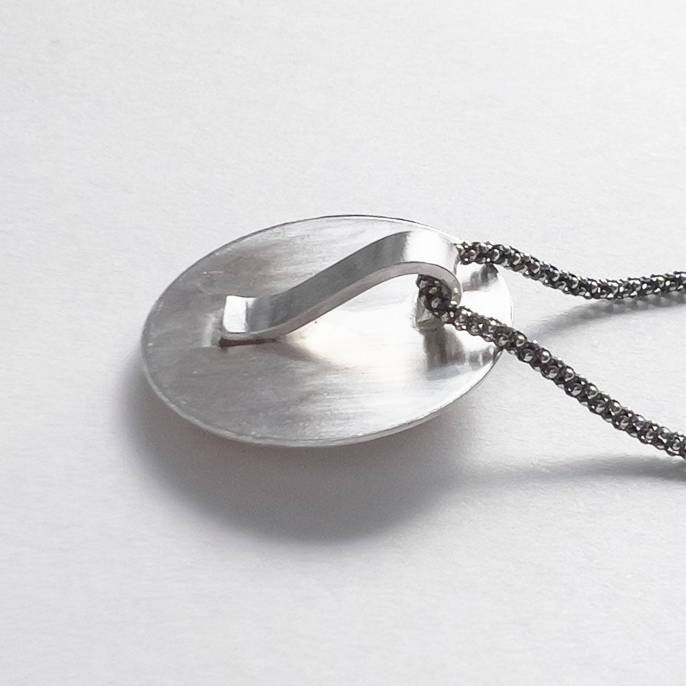 Back of sterling silver fox pendant showing the hidden handmade bail.