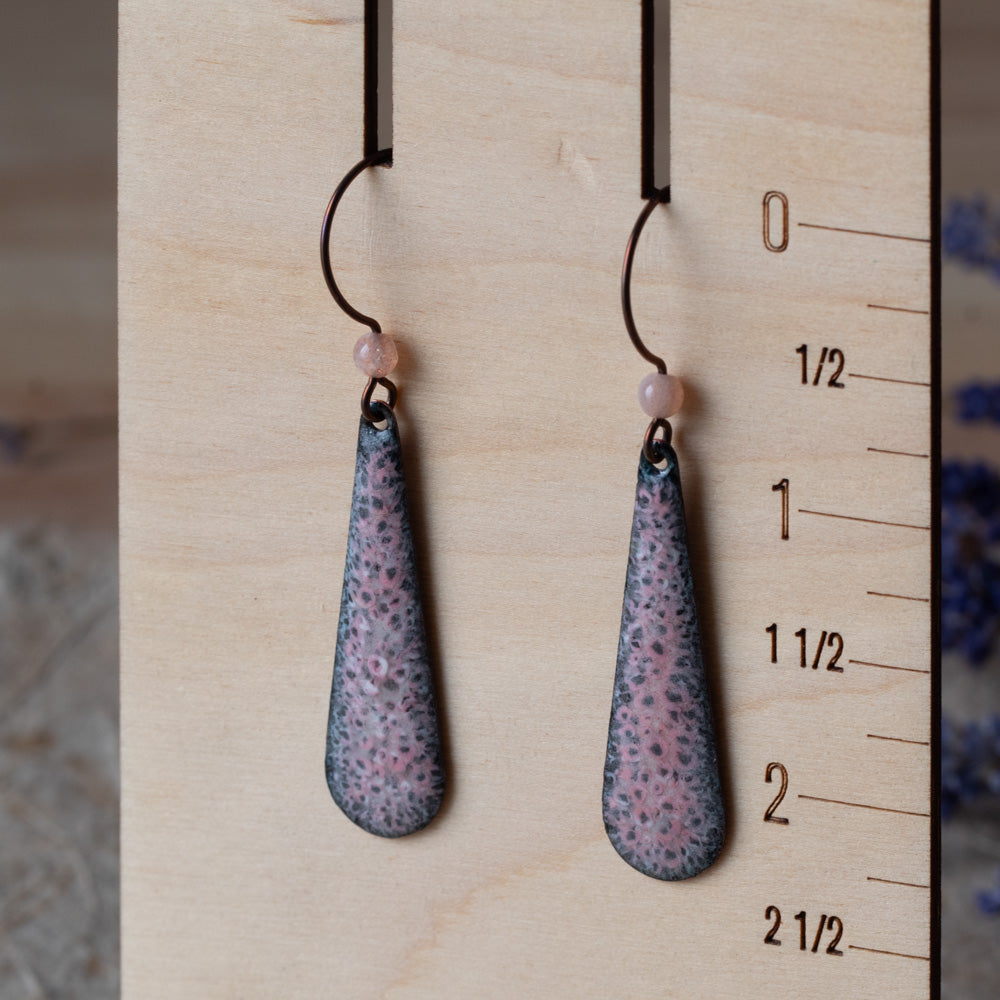 Pink enamel teardrop earrings with dark speckled detail, rose quartz beads, and niobium ear wires.