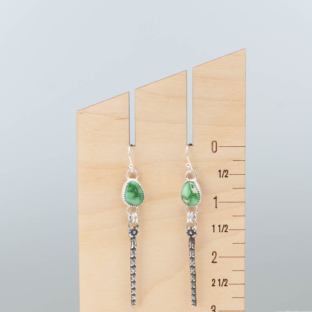 Long sterling silver and turquoise earrings shown on measurement display