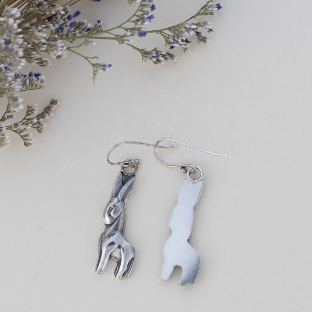 Front and back of handmade fine and sterling silver donkey dangle earrings with detailed sculpted design, featuring playful animal-inspired jewelry with artisan charm.