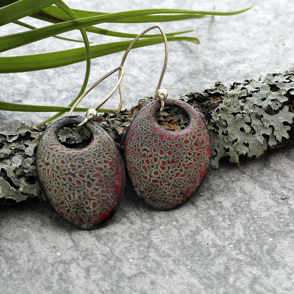 Handmade oval dangle earrings with red and gray kiln-fired enamel on copper and gold -filled ear wires.