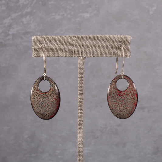 Handmade oval dangle earrings with red and gray kiln-fired enamel on copper and gold -filled ear wires.