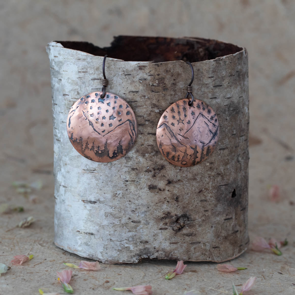 Handcrafted copper disc earrings etched with starlit mountain landscape design, featuring rustic patina and nature-inspired celestial style for outdoor lovers. Niobium ear wires.