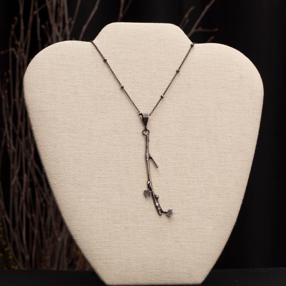Handmade fused sterling silver necklace with detailed 3 1/4" branch pendant and tiny maple leaves on an 18-inch oxidized chain, woodland nature jewelry.