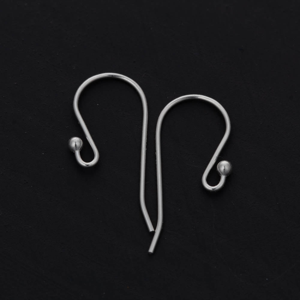 Two silver earring hooks on a black background