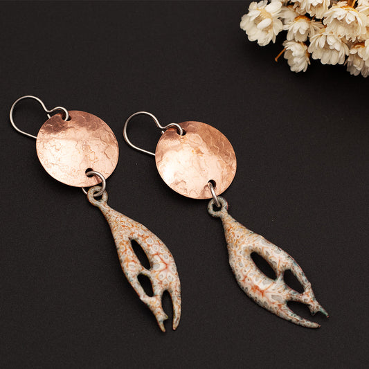 Handmade copper and enamel earrings with organic shape and hammered disc in sandy beige and cloudy gray.