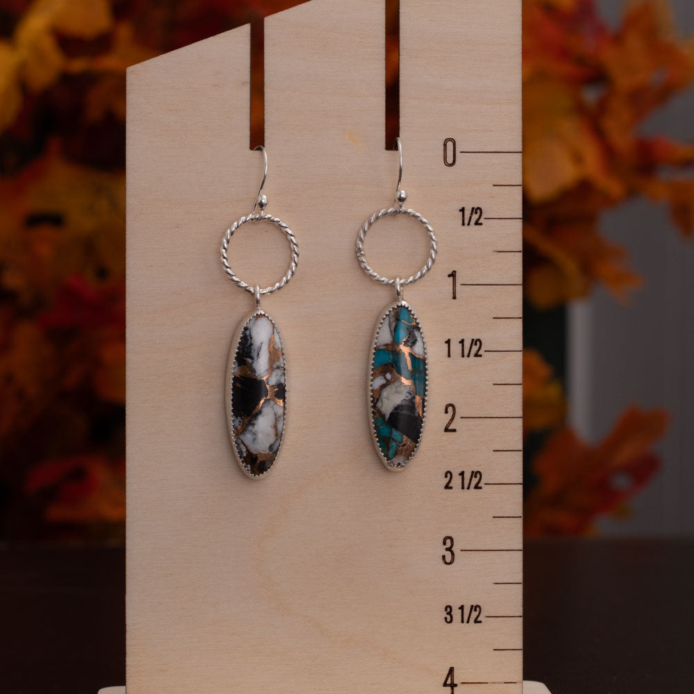 White Buffalo Kingman turquoise composite earrings with bronze matrix, fine silver settings, textured sterling silver hoops, and sterling silver ear wires, handmade by Divella Designs.
