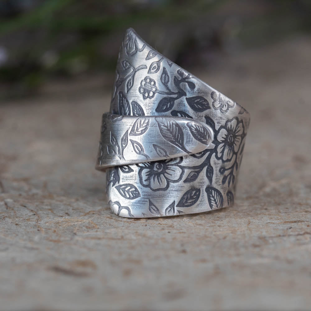 Adjustable sterling silver floral wrap ring by Divella Designs, size 6 3/4 with wildflower texture and patina finish, handmade in Vermont