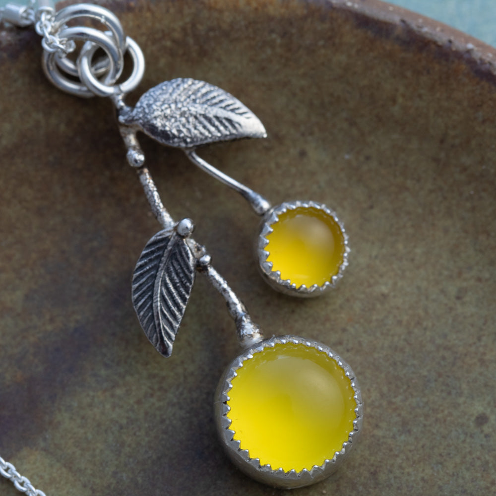 Close-up of yellow chalcedony lemon-inspired pendant with oxidized sterling silver leaves and branch details.
