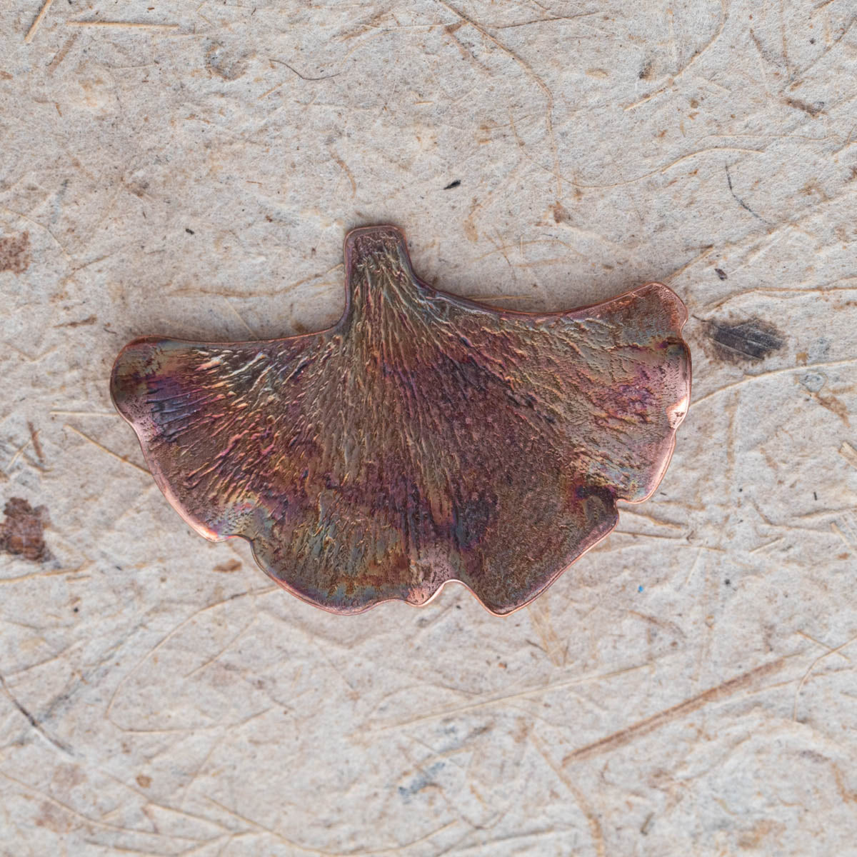Handcrafted copper ginkgo leaf brooch with textured detail and organic fan shape, featuring nature-inspired botanical design and warm earthy patina.