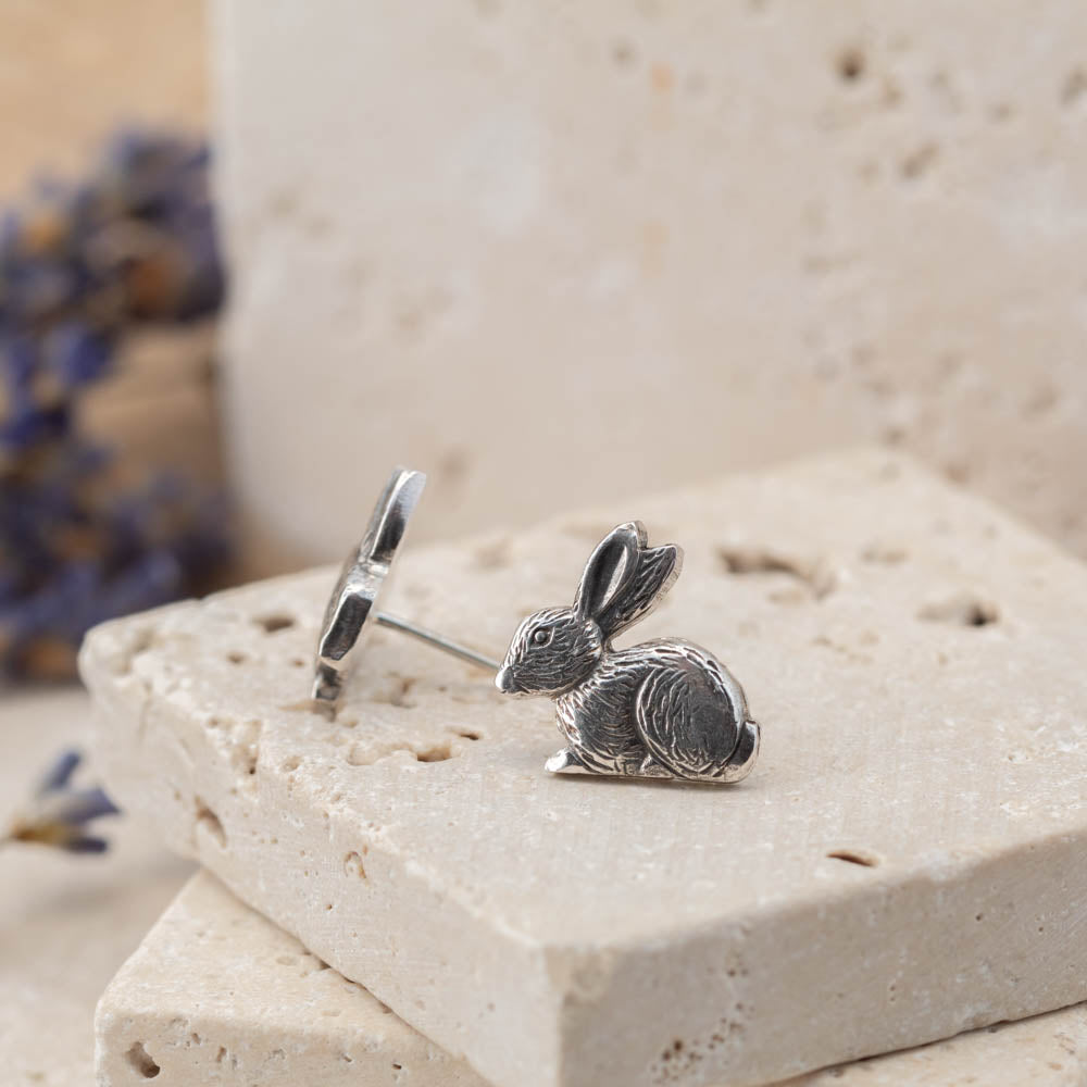 sterling silver bunny stud earrings on stone background