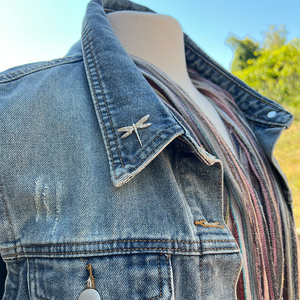 silver dragonfly on a denim vest