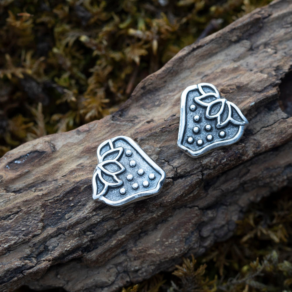 Handcrafted silver strawberry stud earrings with leafy detail and dotted texture, featuring whimsical fruit-inspired design and rustic botanical charm.