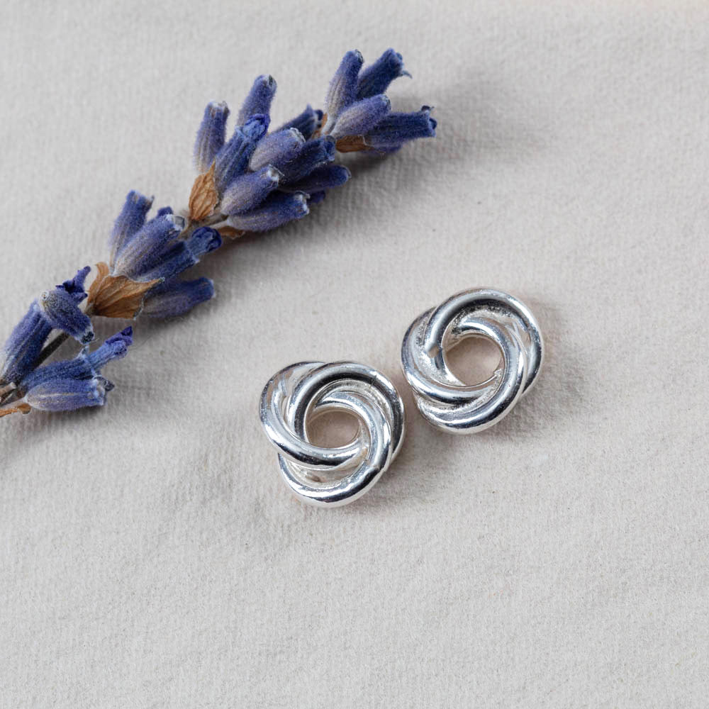 Sterling silver knot earrings with a bright polished finish. Simple, sculpted, and handmade in Vermont — the perfect everyday pair.