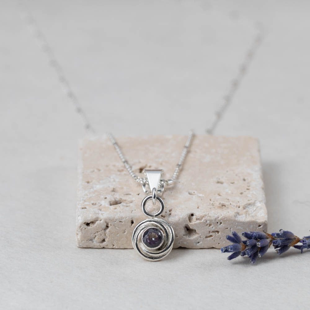 Sterling silver pendant necklace with simulated alexandrite that shifts from greenish-blue to deep violet, handmade in Vermont by Divella Designs.
