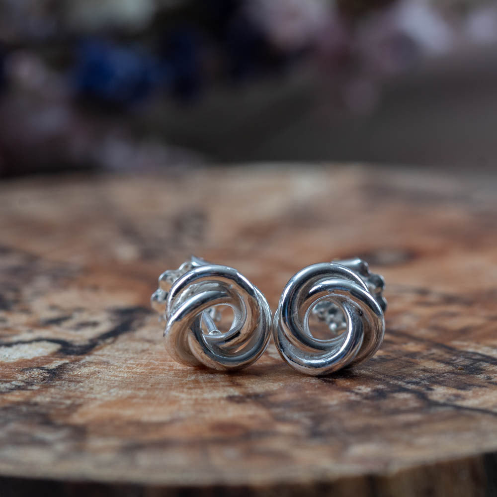 Sterling silver knot earrings with a bright polished finish. Simple, sculpted, and handmade in Vermont — the perfect everyday pair.