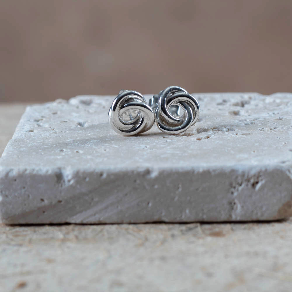 Sterling silver knot earrings with a bright polished finish. Simple, sculpted, and handmade in Vermont — the perfect everyday pair.