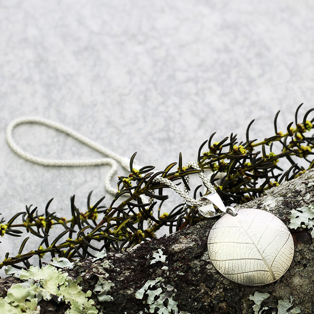 Silver Leaf Print Necklace on bark