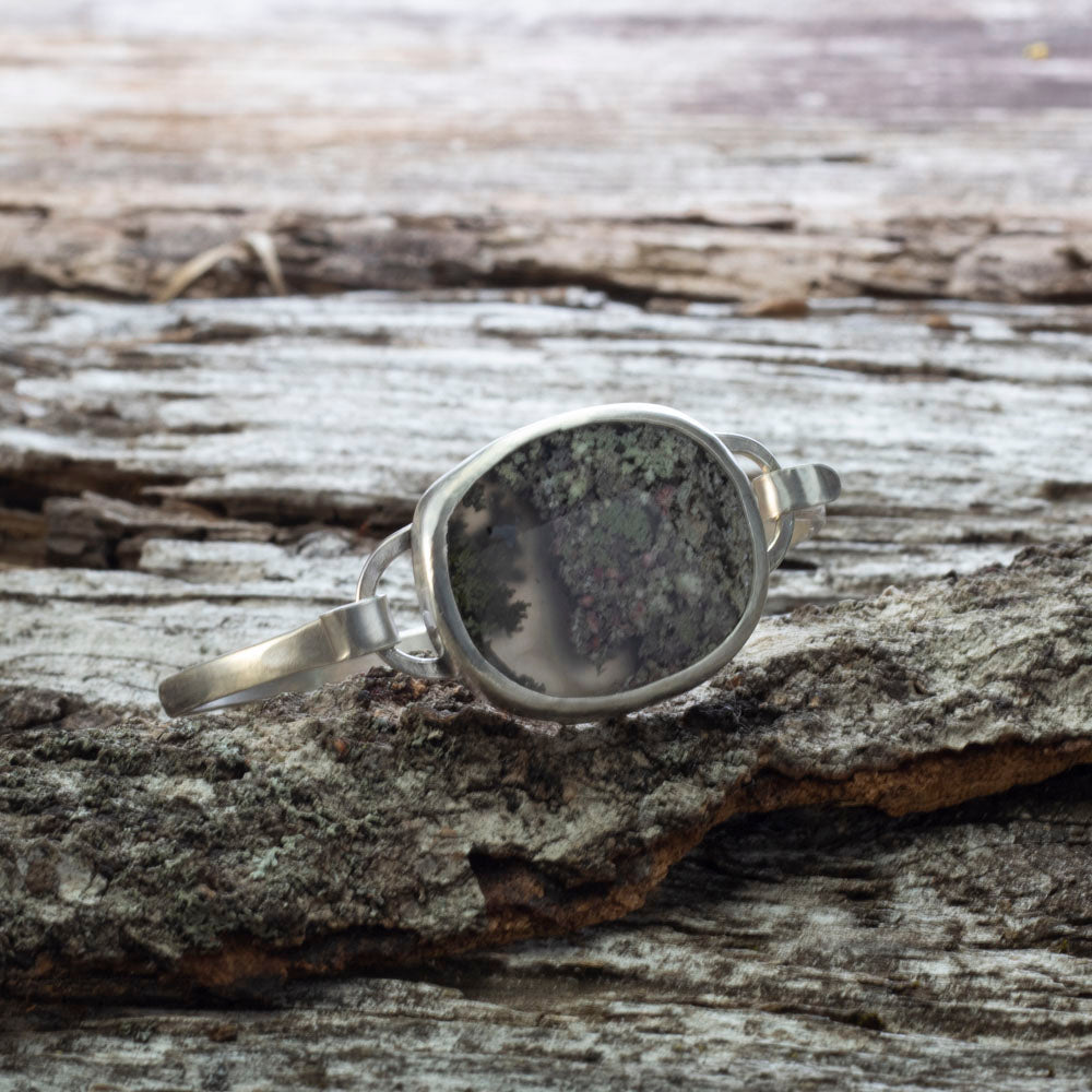 Sterling silver tension cuff with dendritic agate resembling a miniature landscape