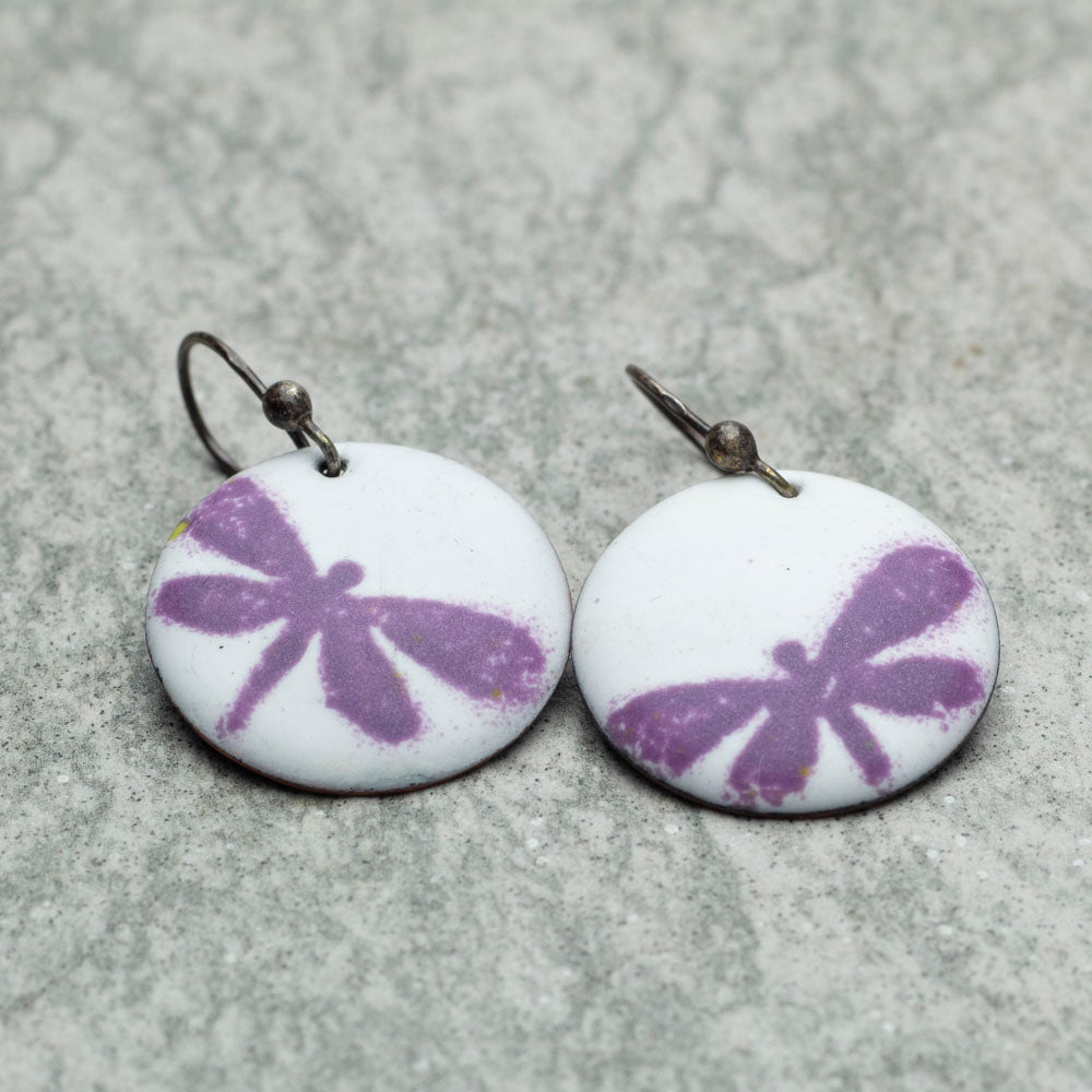 White kiln-fired enamel earrings with purple dragonflies and niobium ear wires