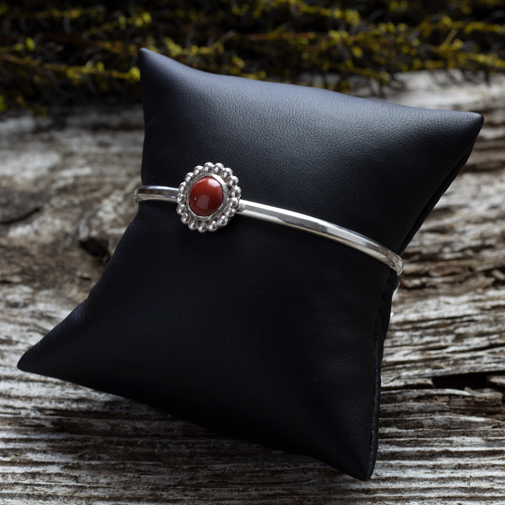 Sterling silver cuff bracelet with red jasper cabochon and beaded floral bezel, handmade jewelry