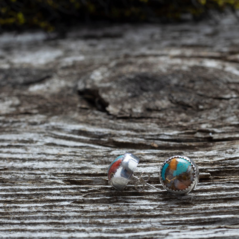 Sterling silver stud earrings with 10mm spiny turquoise stones in vibrant swirls of teal, coral, and rust, handcrafted with a serrated bezel setting.