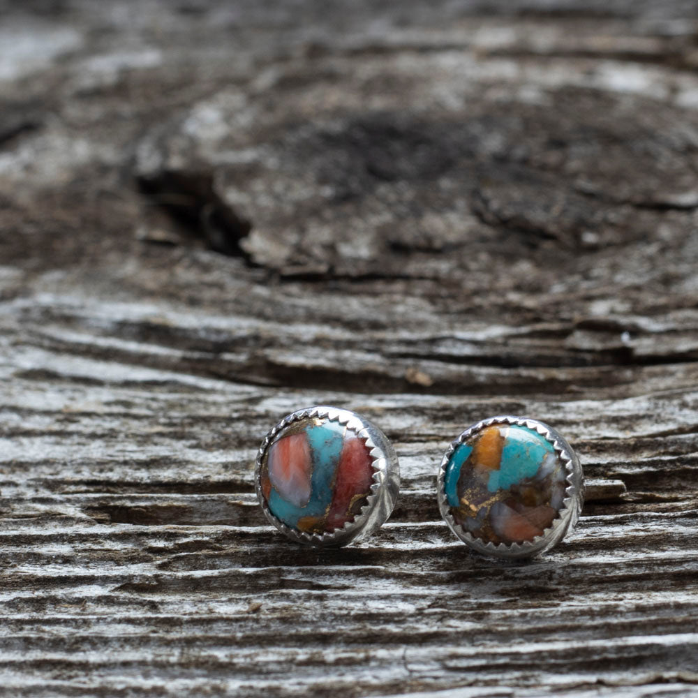 Sterling silver stud earrings with 10mm spiny turquoise stones in vibrant swirls of teal, coral, and rust, handcrafted with a serrated bezel setting.