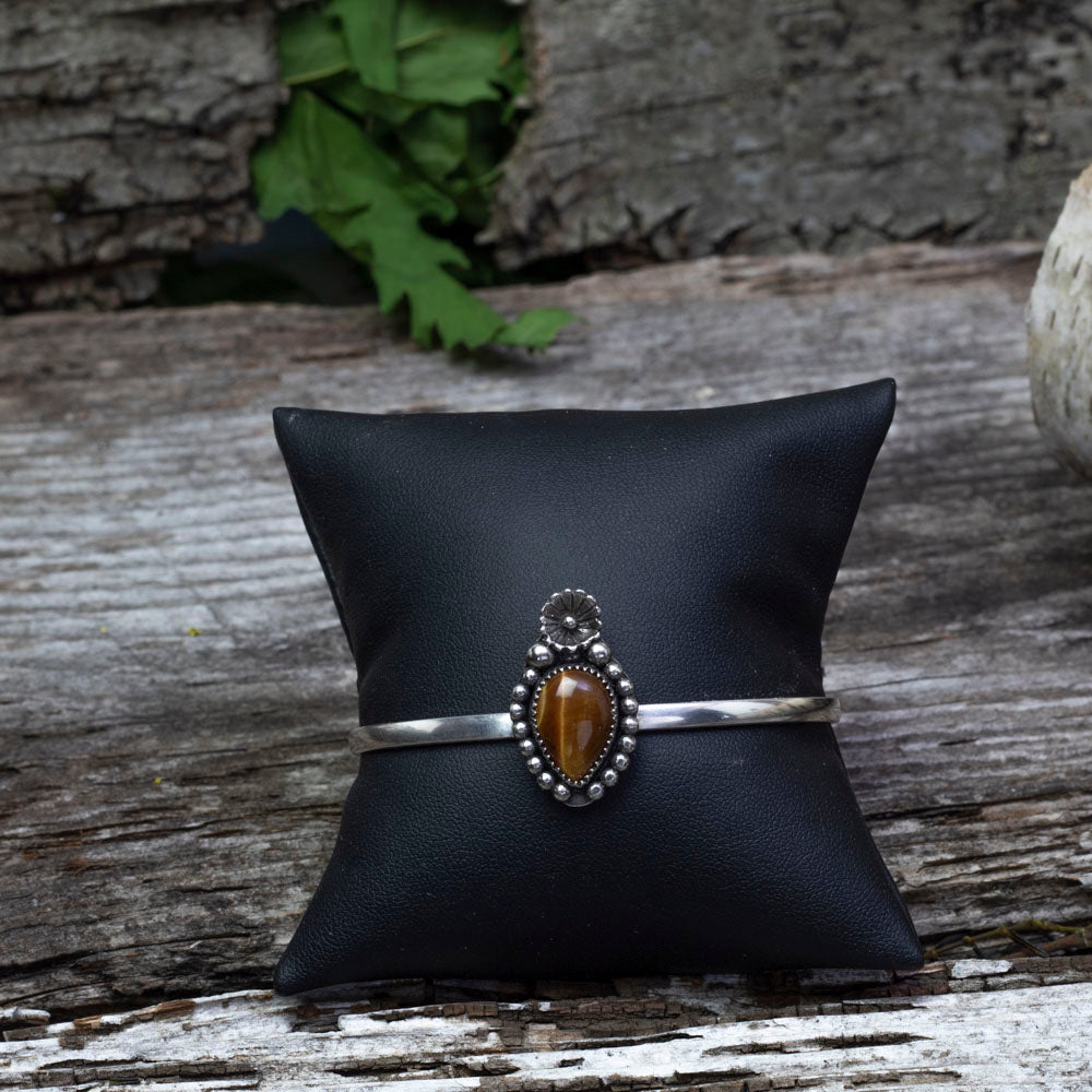 Sterling silver cuff bracelet with tiger’s eye cabochon in floral and beaded setting, handmade jewelry
