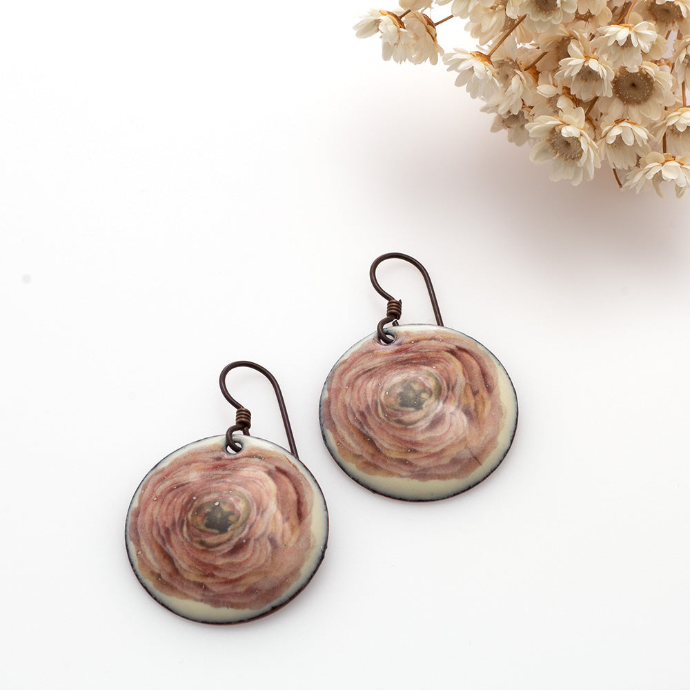 Round enamel earrings with soft pink ranunculus flower design on copper and niobium ear wires.