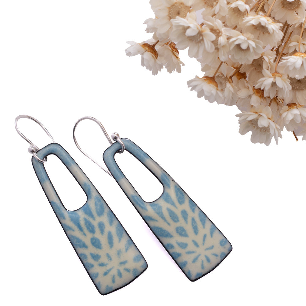 Handmade enamel earrings with pale blue botanical pattern, rectangle drop shape, sterling silver ear wires.