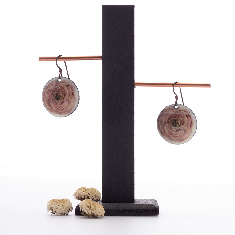 Round enamel earrings with soft pink ranunculus flower design on copper and niobium ear wires.