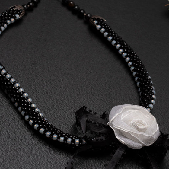 black and white bead crochet necklace with rosette ribbons
