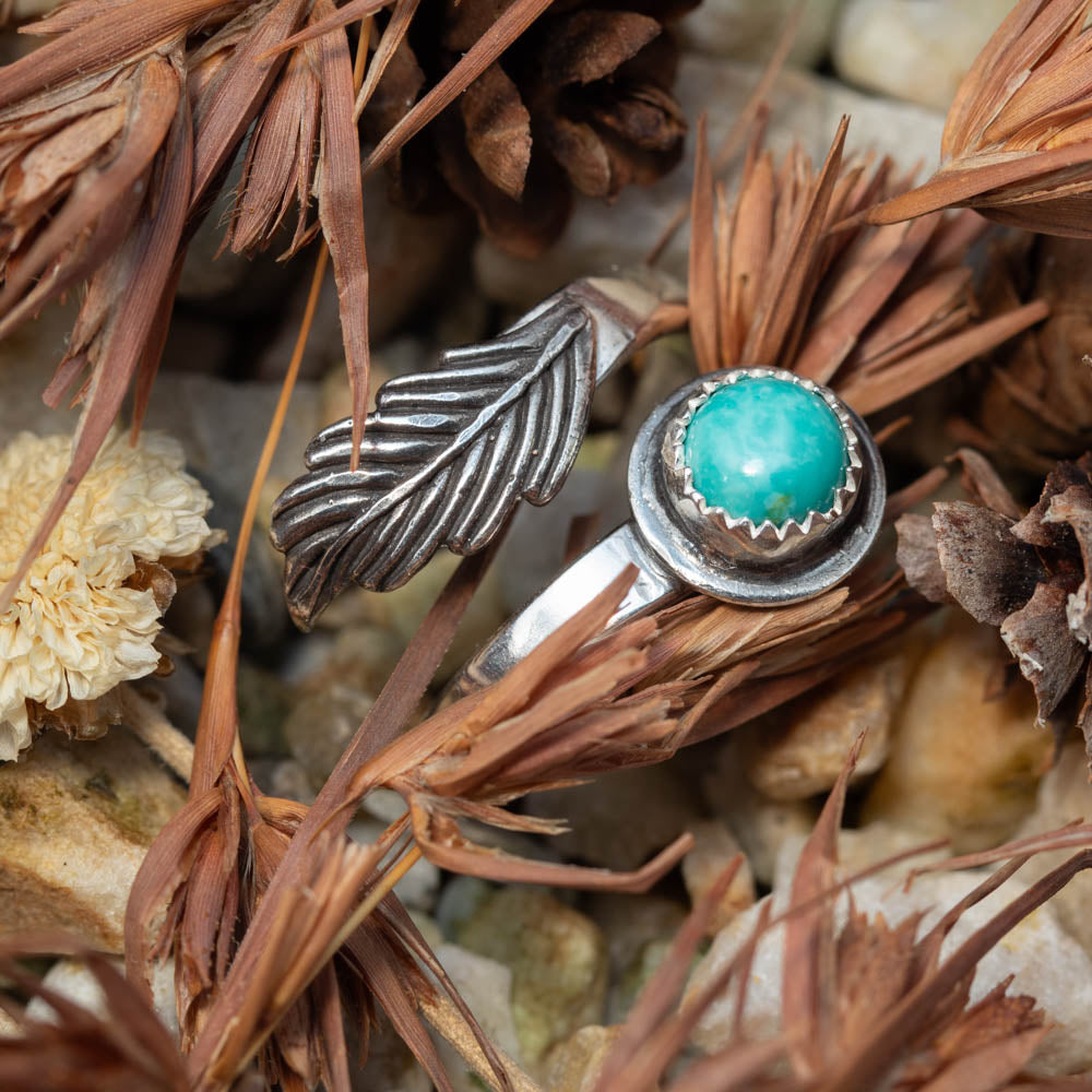 kingman turquoise and Silver ring with turquoise stone on a bed of dried plants and stones