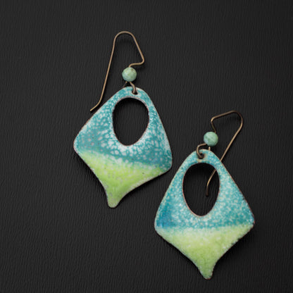 Handcrafted enamel earrings featuring a gradient of aqua blue and lime green with a speckled texture, diamond cutout design, and niobium ear wires accented with light green gemstone beads.