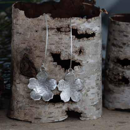 Sterling silver botanical impression earrings by Divella Designs, handmade in Vermont with floral textured pattern and satin finish, 2 1/2" drop on curved ear wires