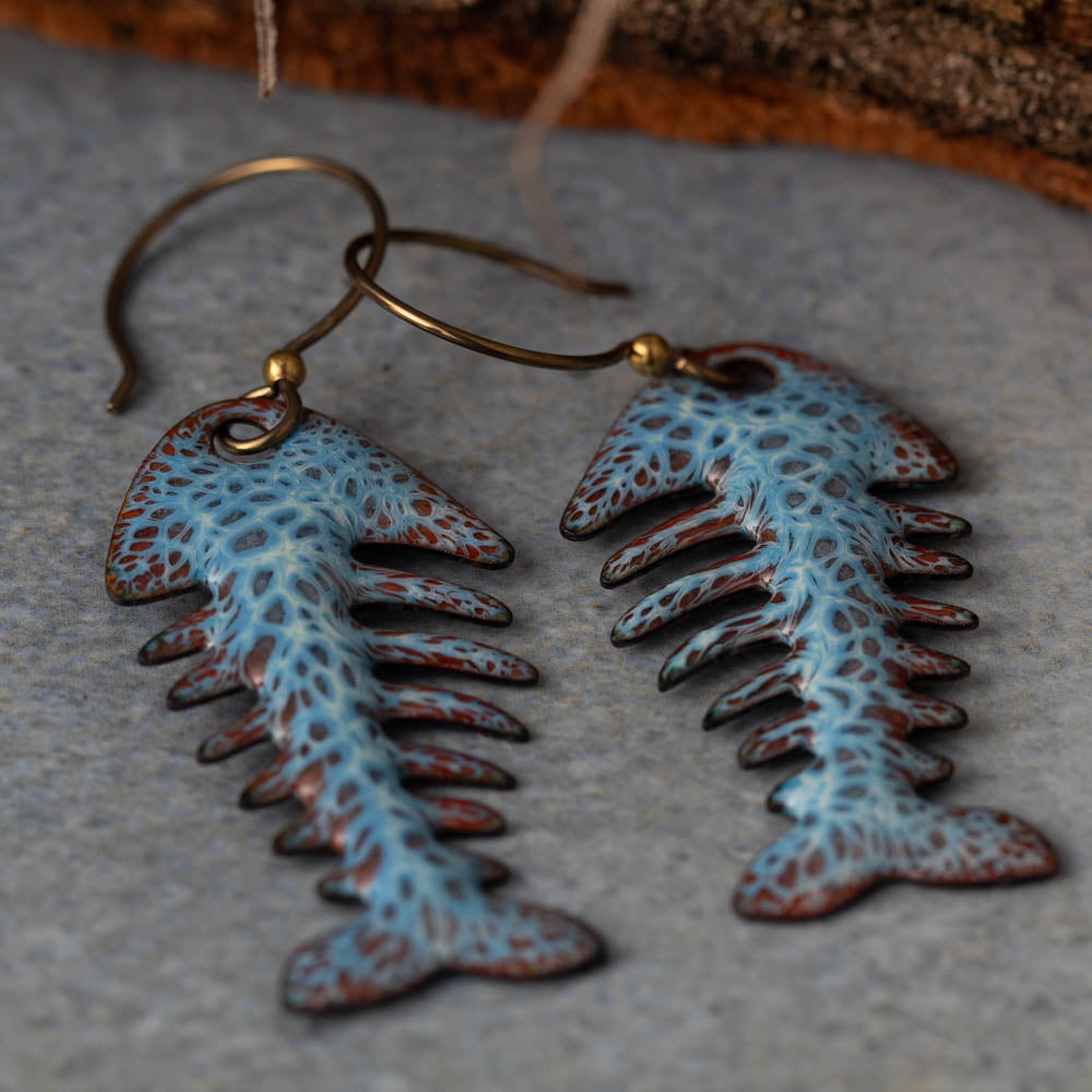 Colorful kiln-fired enamel fishbone earrings on copper with niobium ear wires, handmade by Divella Designs in Vermont.