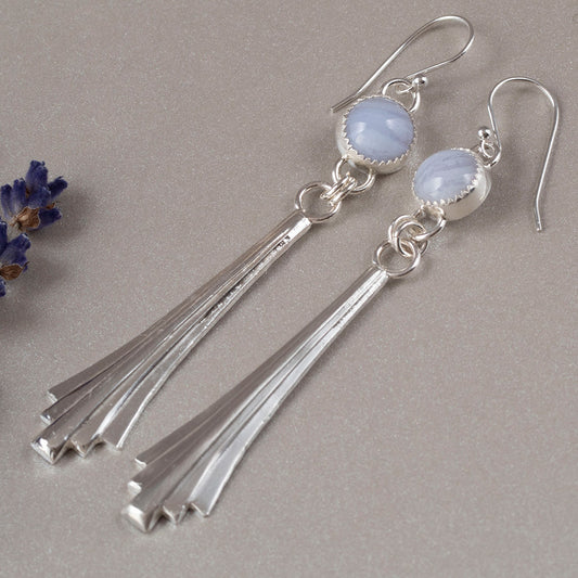 Handmade sterling silver dangle earrings with fan-shaped cascading drops and round blue lace agate gemstones, featuring a modern artisan design with soft pastel tones.