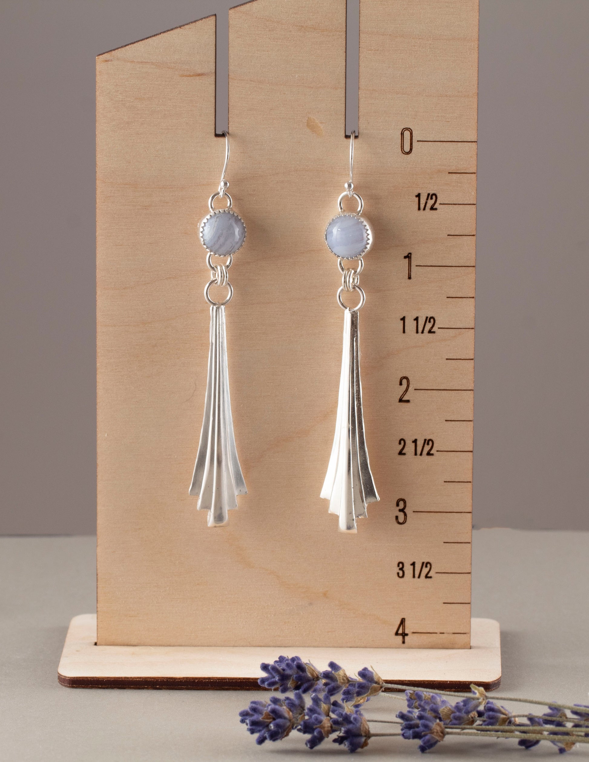 Handmade sterling silver dangle earrings with fan-shaped cascading drops and round blue lace agate gemstones, featuring a modern artisan design with soft pastel tones. Pictured for measurement.