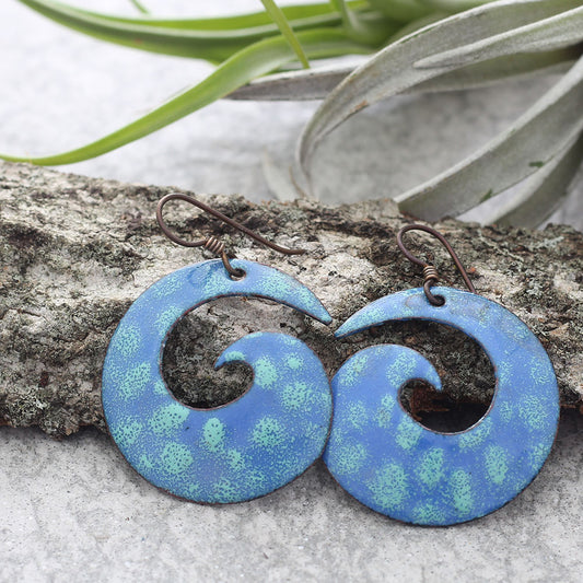 Handmade blue enamel copper spiral earrings with sea-inspired swirl design and hypoallergenic niobium ear wires. Lightweight artistic dangle earrings.