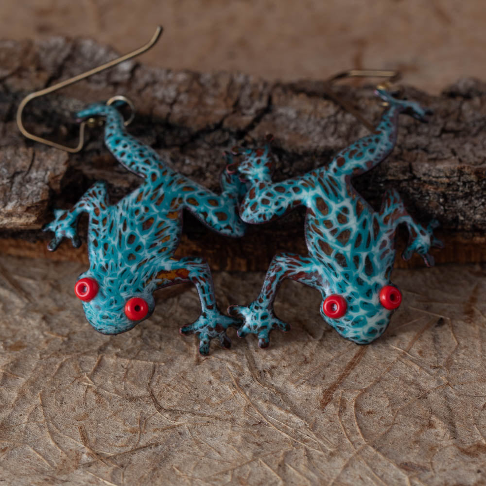 Handmade enamel tree frog earrings on bark by Divella Designs.
