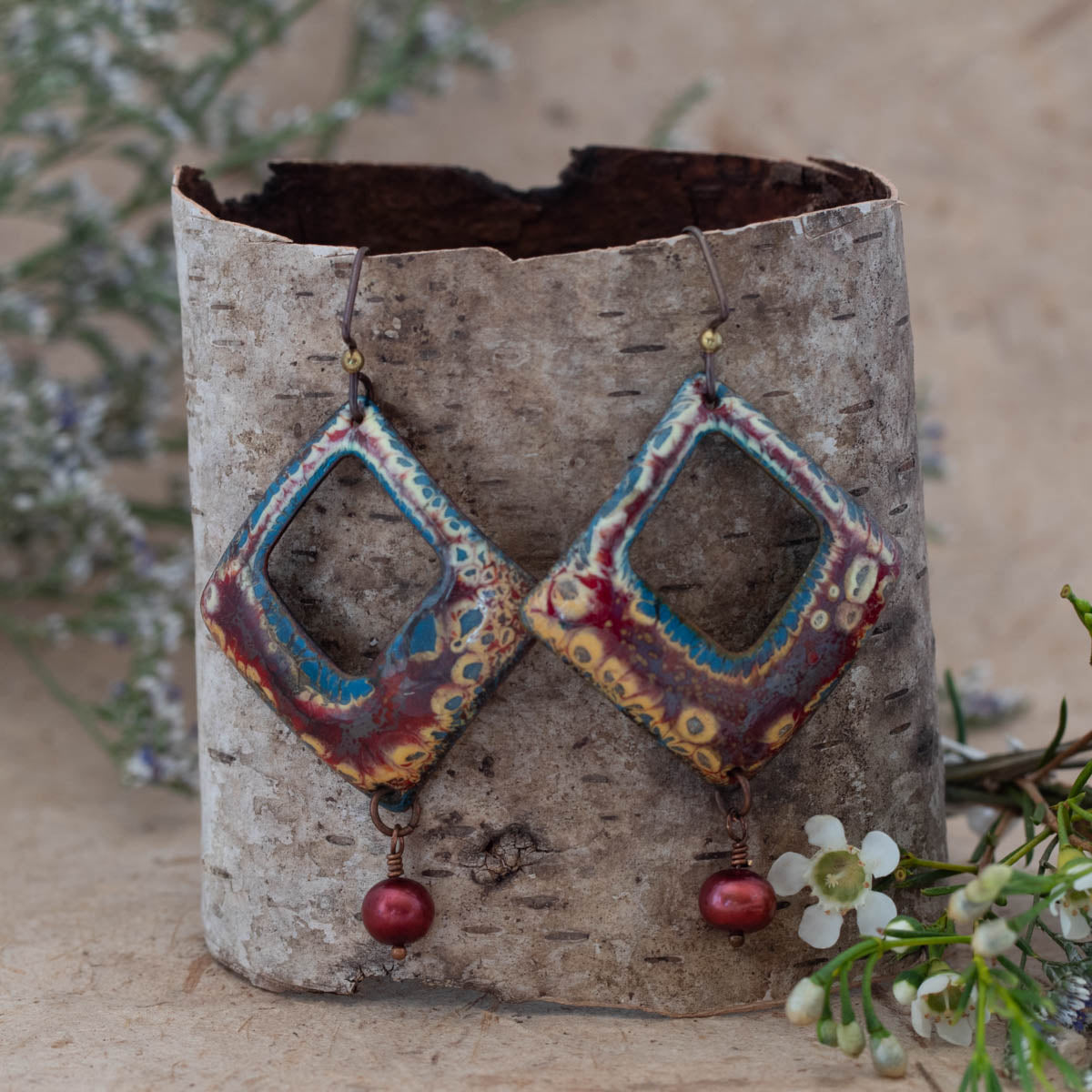 Burgundy, ochre, and teal enamel pearl openwork earrings with freshwater pearl drops and niobium ear wires, handmade by Divella Designs.