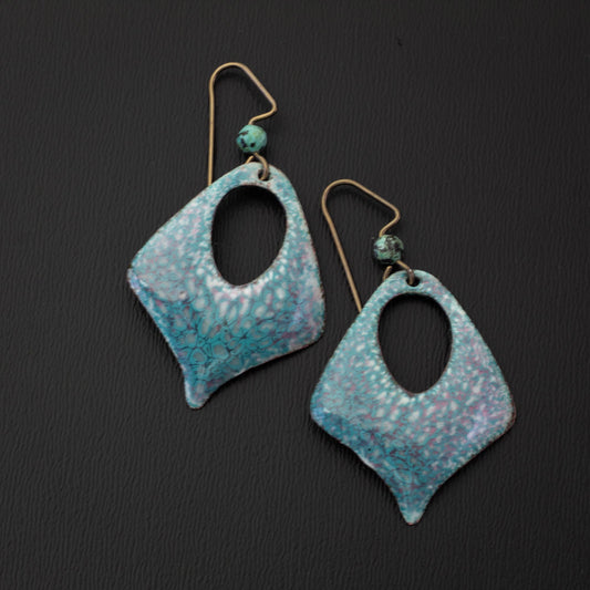Pastel enamel earrings in soft sky blue and pink with a dappled crackle texture, diamond shape cutout design, handcrafted with niobium ear wires and matching blue gemstone accents.