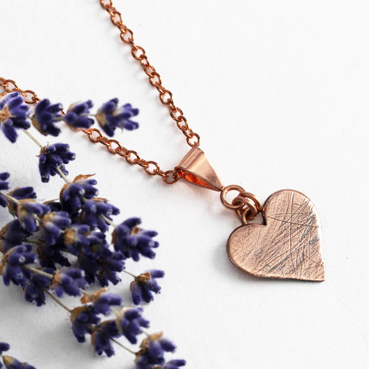 Custom copper heart necklace infused with pet hair, fur, or feathers, handcrafted keepsake charm on a delicate chain, styled with dried lavender – personalized memorial jewelry by Divella Designs