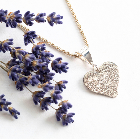 Custom sterling silver heart necklace infused with pet hair, fur, or feathers, handcrafted keepsake charm on a delicate chain, styled with dried lavender – personalized memorial jewelry by Divella Designs
