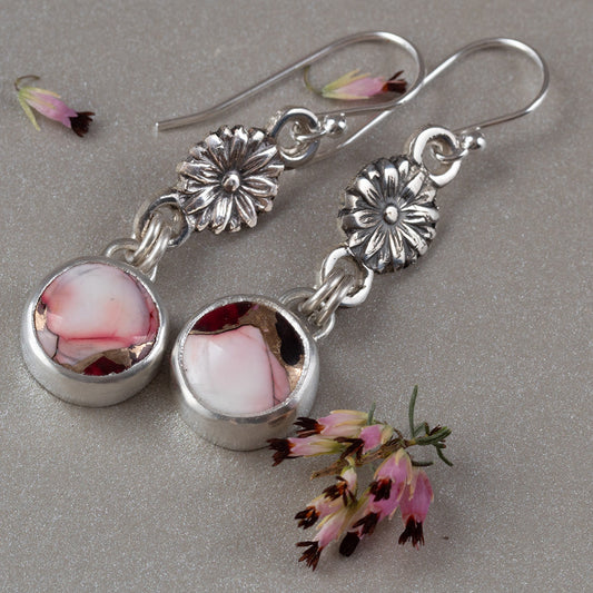 Handmade sterling silver dangle earrings with floral link accents and round pink and red dahlia jasper stones, featuring botanical artisan design with romantic charm.